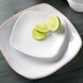 A Tuxton Artisan china plate with limes on it.