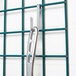 A metal hook from the Metro SmartWall G3 Food Prep Accessory Pack attached to a grid.