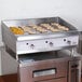 A Cooking Performance Group 36" gas griddle with a cabinet base.