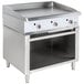 A Cooking Performance Group stainless steel gas griddle with knobs on a cabinet base.