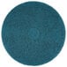 A blue 3M circular floor pad with a circle in the middle.