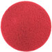 A red circular 3M floor pad with a circle in the middle.