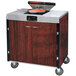 A Lakeside mobile cooking cart with an induction burner and a pan on it.