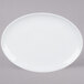An Arcoroc white porcelain platter with a rim on a gray surface.