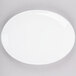A white Chef & Sommelier oval platter on a gray surface.