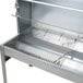 A stainless steel Optimal Automatics Party Que charcoal rotisserie grill with a rack inside.