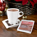 A cup of Nestle hot chocolate on a table with a packet of chocolate.