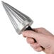 A hand holding a silver Carnival King Waffle Cone forming tool with a black handle.