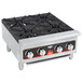 A Vollrath countertop gas range with four burners.