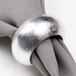 An American Atelier silver round acrylic napkin ring on a napkin.