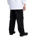 A person wearing black Chef Revival chef pants.