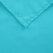 A close up of a teal hemmed cloth table cover.