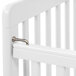 A close-up of a white L.A. Baby Little Wood crib with a metal handle.