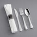 A Visions silverware set with a white napkin and silver plastic cutlery.