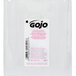 A clear plastic bottle of GOJO® Clear & Mild foaming hand soap with a white label.