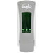 A grey GOJO® soap dispenser with a green light.