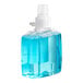 A plastic bottle of blue liquid hand soap.