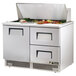 A True stainless steel sandwich prep table with drawers.
