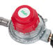 A red gas regulator with a red and silver cap.