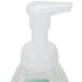 A white plastic pump with a white handle on a bottle of GOJO Green Certified Fragrance Free foaming hand soap.