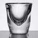 A close-up of a clear Anchor Hocking shot glass.