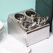 A Steril-Sil stainless steel countertop flatware organizer holding silverware.
