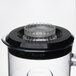 A Waring clear plastic blender jar with a black lid and blade.