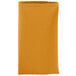 A folded orange Intedge cloth napkin on a white background.