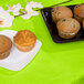 A table set with a Fresh Lime Green table cover with a plate of muffins on it.