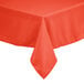 An orange Intedge square cloth table cover on a table outdoors.