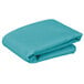 A stack of teal Intedge square table cloths on a white background.