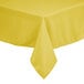 A yellow rectangular polyester table cover on a table.