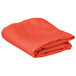 A folded orange cloth table cover.