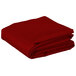 A stack of red folded rectangular Intedge table covers on a white background.