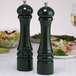 A Chef Specialties forest green salt and pepper mill set on a table.