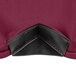 A close-up of a burgundy spandex fabric with a black corner.