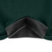 A close up of a black plastic corner on a hunter green spandex table cover.