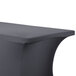 A charcoal Snap Drape spandex table cover on a table with a curved edge.