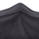 A close up of the black fabric of a Snap Drape Contour Table Cover.