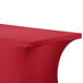 A crimson Snap Drape Contour table cover on a table with a curved edge.