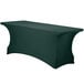 A hunter green Snap Drape Contour Table Cover with curved edges on a table.