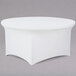 A white round table with a Snap Drape white spandex contour cover.