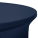 A navy blue Snap Drape spandex contour table cover on a round table.