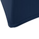 A navy blue Snap Drape Contour spandex table cover on a table.