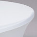 A close-up of a white Snap Drape Contour round table cover on a round table.