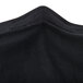 A close up of a black fabric Snap Drape Contour Table Cover.