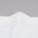 A close up of a white fabric edge with a folded edge.