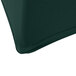 A corner of a hunter green Snap Drape spandex table cover on a table.