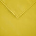 A yellow square cloth table cover with a hemmed edge.