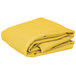 A stack of yellow folded Intedge rectangular table covers on a white background.